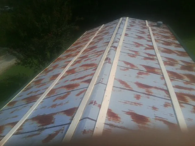 Rusted metal roof panels with new wood purlins before replacement — Storm Damage Roof Repair in Smithsburg by Roofing Brothers