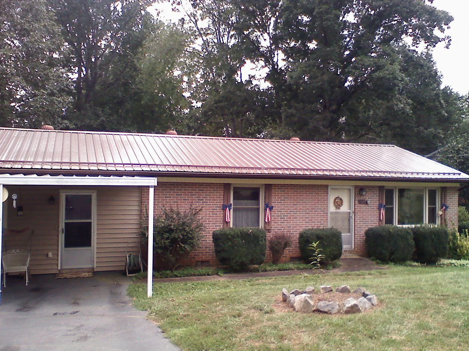 Bronze metal roof and carport on a brick ranch home — Roof Repair work by our crew in Smithsburg